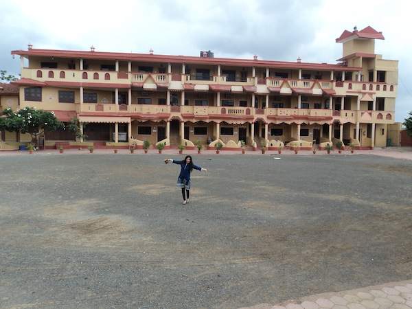 Hunar stands in front of a hotel in Mumbai.